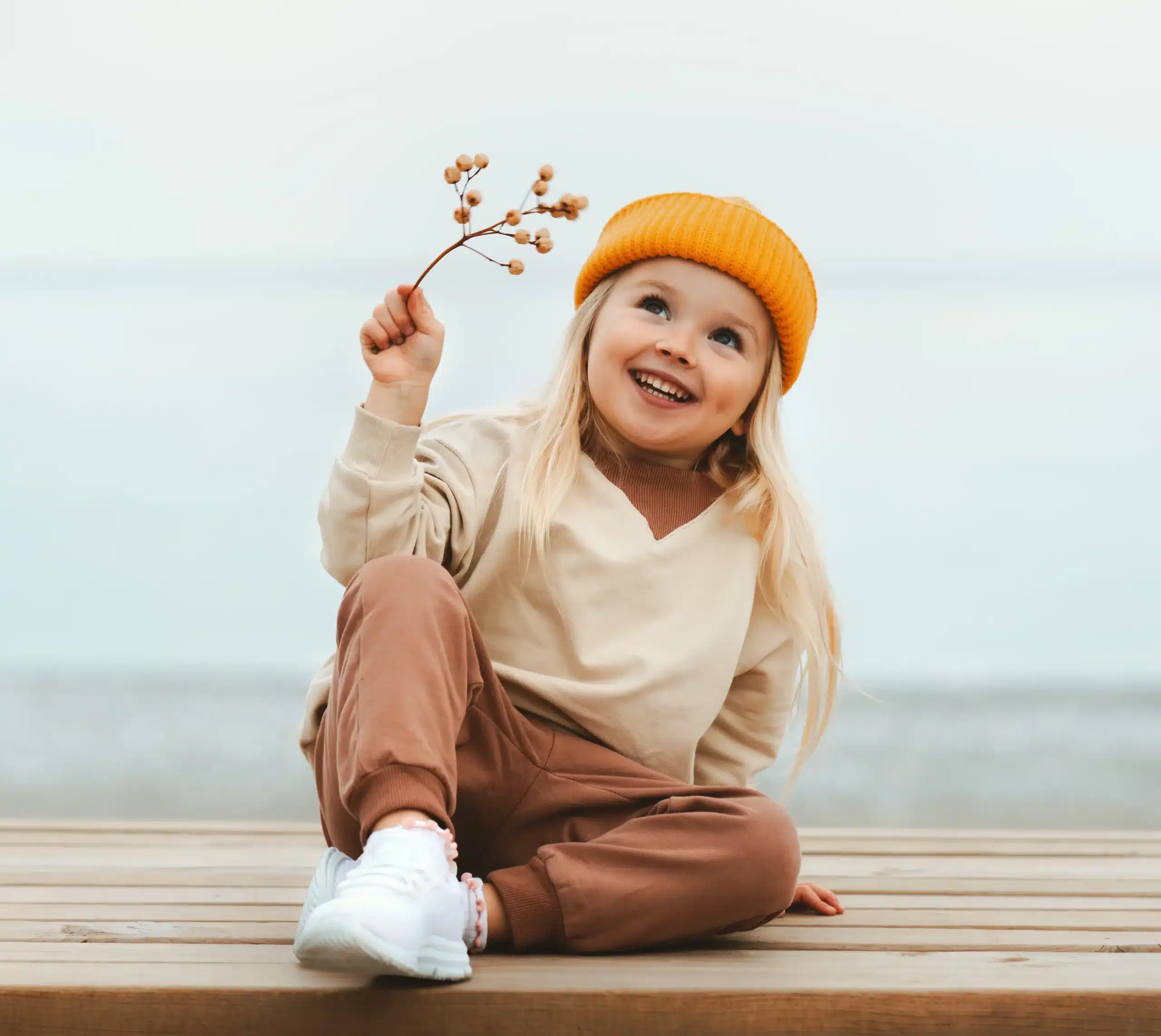 Smiling child sitting outdoors, representing pediatric dental care in Horizon City, TX