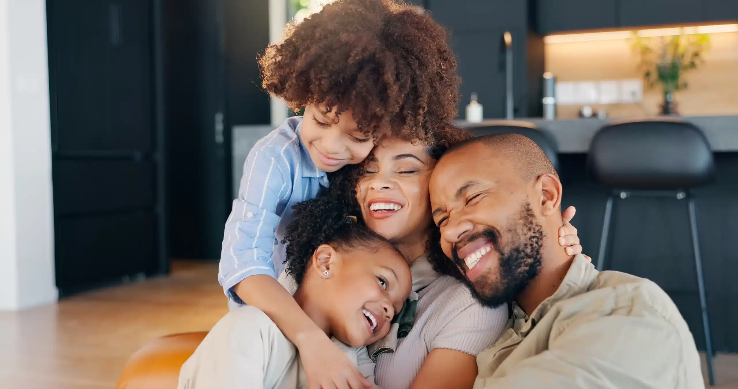 Happy family hugging together, representing confident smiles after dental care | General Dentistry in Horizon City TX