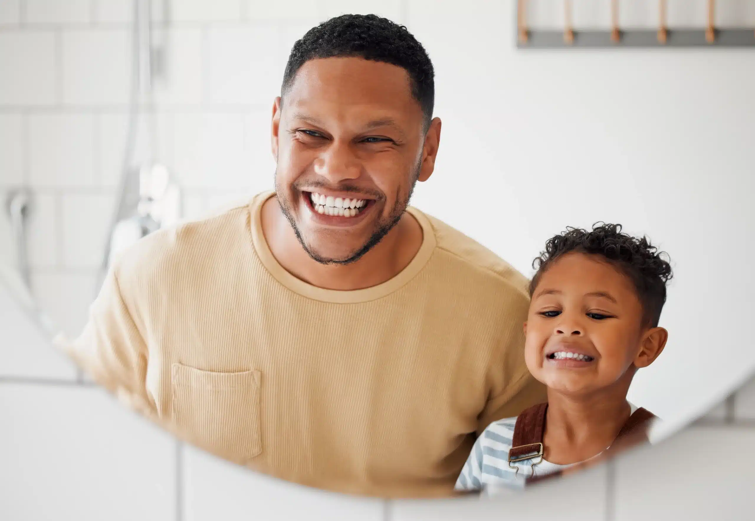 Happy father and child smiling, representing healthy smiles and dental cleanings