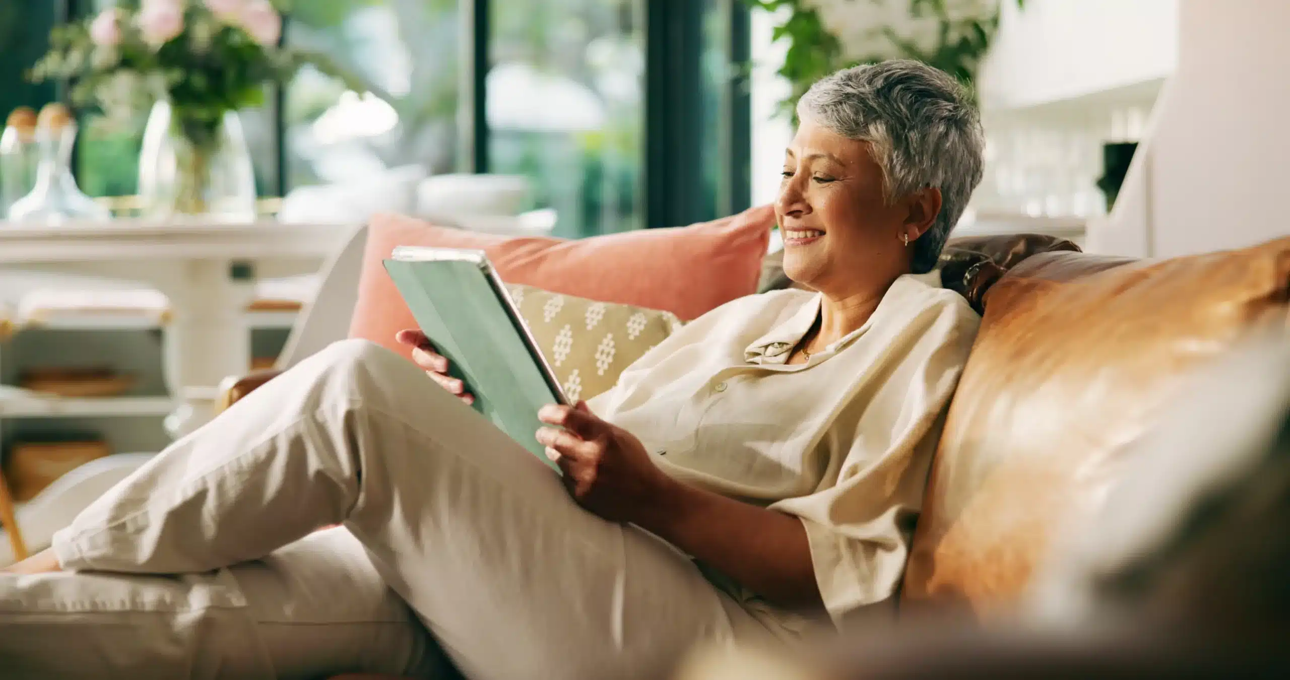 woman using tablet at home, representing convenient financial options at Dyer Family Dental